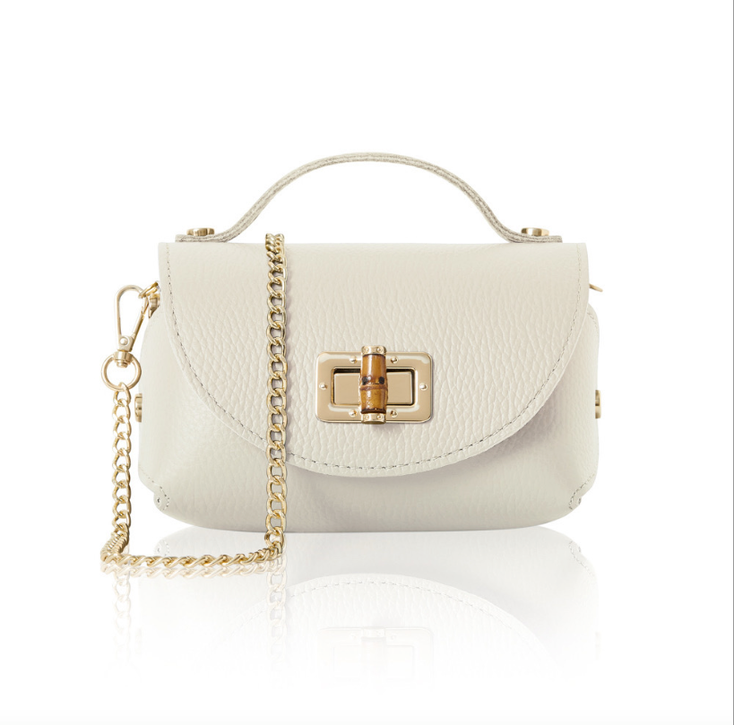 A small, structured Cream leather handbag with a textured finish, featuring a gold turn-lock closure on the front flap, a short top handle, and a detachable gold chain shoulder strap. 