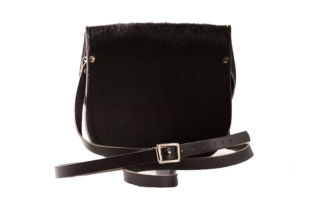 Dark Brown Cowhide Hair and Black Leather handmade saddle cross body handbag with adjustable belt buckle shoulder strap, made in London. Visit out customise section to choose your own colours and have a bespoke custom saddle bag made for you. A to Z Leather LTD