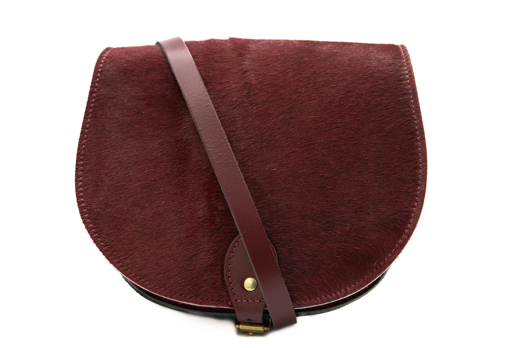 Burgundy cowhide hair Leather handmade saddle cross body handbag with adjustable belt buckle shoulder strap, made in London. Visit out customise section to choose your own colours and have a bespoke custom saddle bag made for you. A to Z Leather LTD