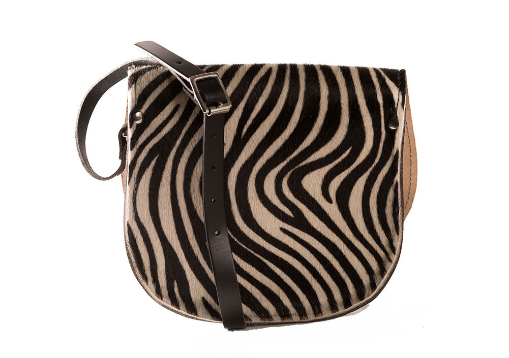 Zebra Patterned Cowhide Hair and Brown Leather handmade saddle cross body handbag with adjustable belt buckle shoulder strap, made in London. Visit out customise section to choose your own colours and have a bespoke custom saddle bag made for you. A to Z Leather LTD