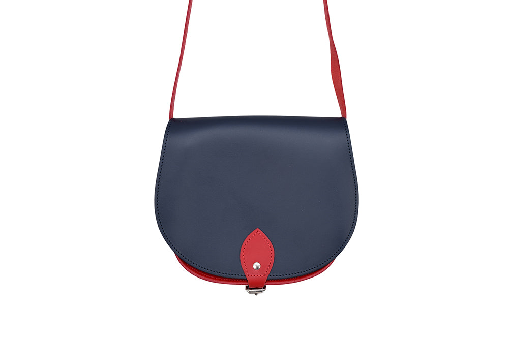 Navy and Red Leather handmade saddle cross body handbag with adjustable belt buckle shoulder strap, made in London. Visit out customise section to choose your own colours and have a bespoke custom saddle bag made for you. A to Z Leather LTD